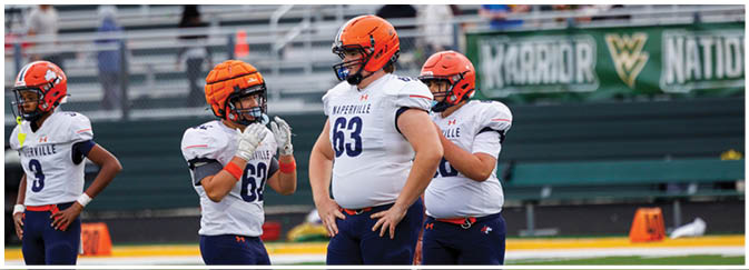 A group of football players on a field. Description generated by AI
