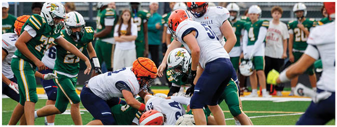 A football player is sliding on the ground. Description generated by AI