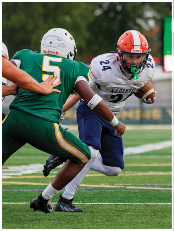 A football player wearing a blue jersey with the number 58 on it. Description generated by AI