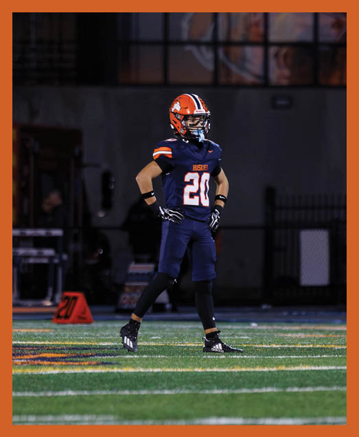 A football player in a white uniform is running with a football in his hand. AI generated content