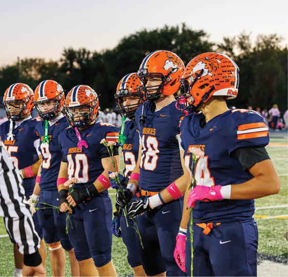 A group of football players celebrating a victory. AI generated content
