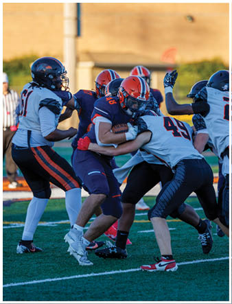 A group of football players on a field. Description generated by AI