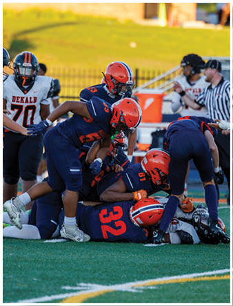 A group of football players on a field. Description generated by AI