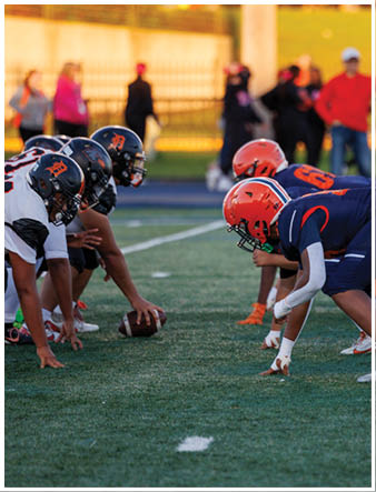 A group of football players on a field. Description generated by AI
