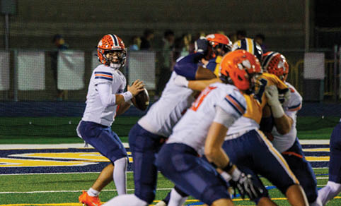 Two men wearing football uniforms are hugging each other on a field. AI generated content