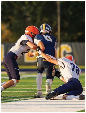 A group of football players on a field. Description generated by AI