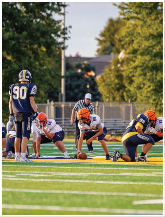 A group of football players on a field. Description generated by AI