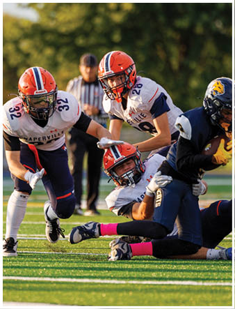 A group of football players on a field. Description generated by AI