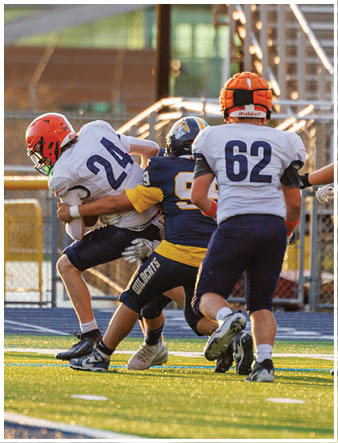 A group of football players on a field. Description generated by AI