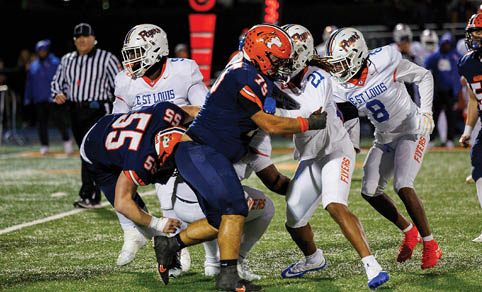 Two men wearing football uniforms are hugging each other on a field. AI generated content