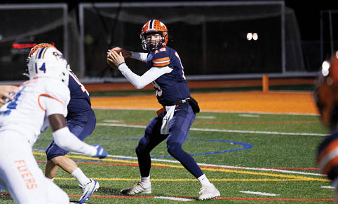 Two men wearing football uniforms are hugging each other on a field. AI generated content