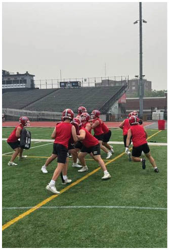 A football game is being played on a field. Description generated by AI