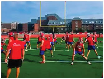 A group of football players on a field. Description generated by AI