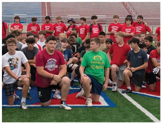A group of football players on a field. Description generated by AI