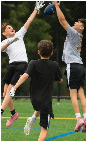 A football player catching a ball. Description generated by AI