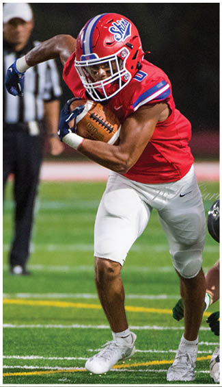 A football player running on the field. Description generated by AI