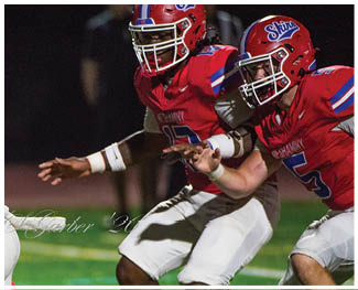 A football player running on the field. Description generated by AI
