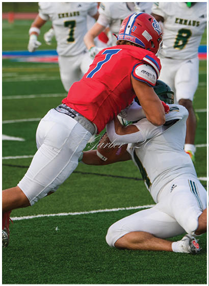 A football player wearing a blue jersey with the number 58 on it. Description generated by AI
