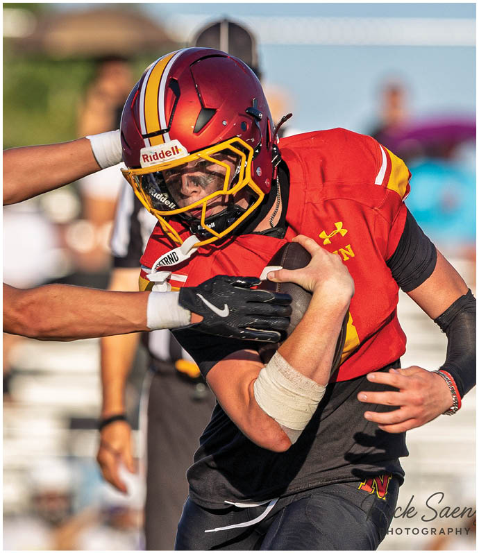 Two football players are fighting for the ball. Description generated by AI