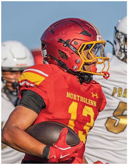 A football player in a red and yellow jersey with the number 13 on it. Description generated by AI