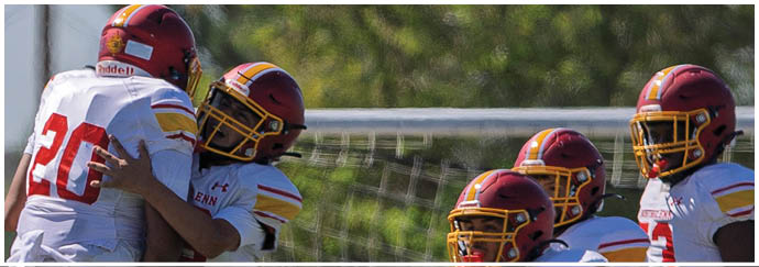Two football players jumping in the air. Description generated by AI