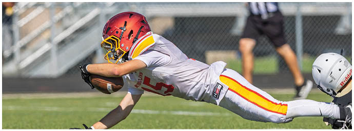 A football player slides into a base. Description generated by AI