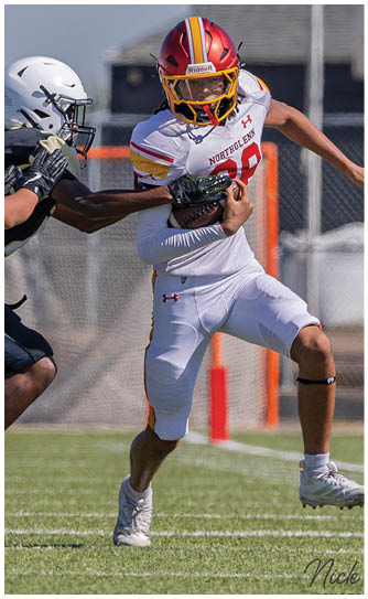 A football player in a white jersey with the number 28 on it. Description generated by AI
