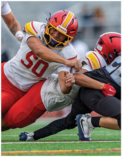 Two football players are on the ground. Description generated by AI
