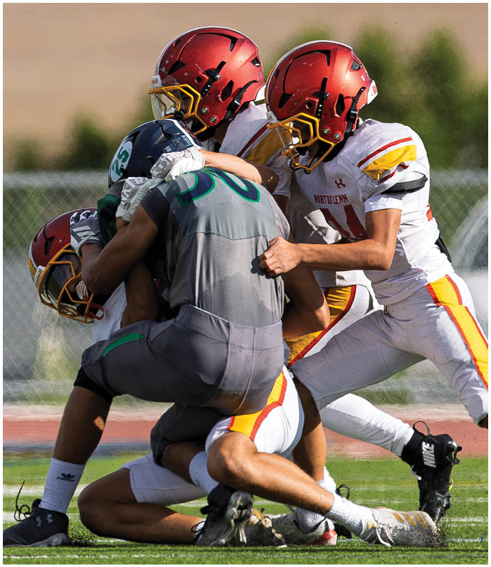 A group of football players on the field. Description generated by AI