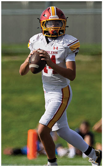 A football player wearing a white jersey with the number 14 on it. Description generated by AI