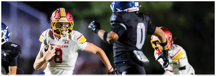 A football player wearing a white jersey with the number 8 running on the field. Description generated by AI