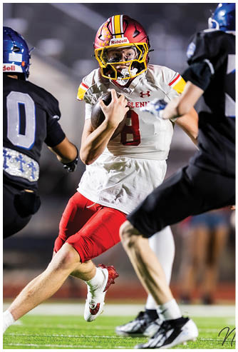 A football player wearing a red and white uniform with the number 8 on the back. Description generated by AI