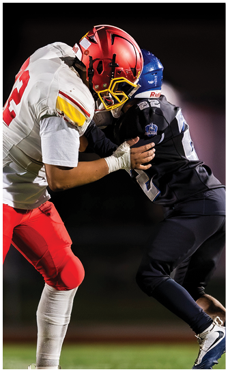 Two football players on a field. Description generated by AI