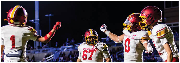 A group of football players celebrating a touchdown. Description generated by AI
