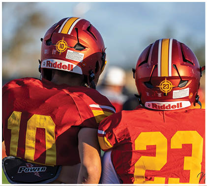 A football player wearing a red and white jersey with the number 13 on it. Description generated by AI
