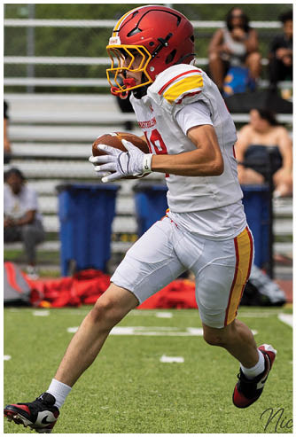 A football player running on the field. Description generated by AI