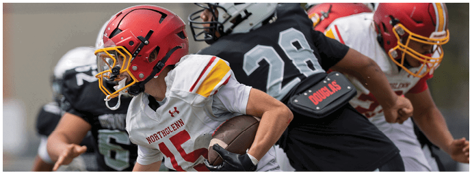 A football player in a red and white jersey running with the ball. Description generated by AI