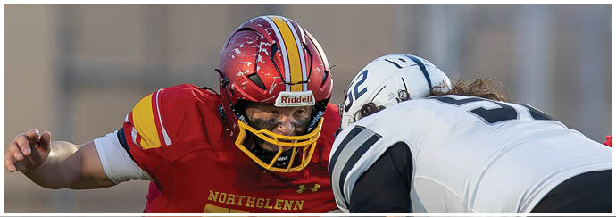 A football player in a red jersey with the number 75 on it. Description generated by AI