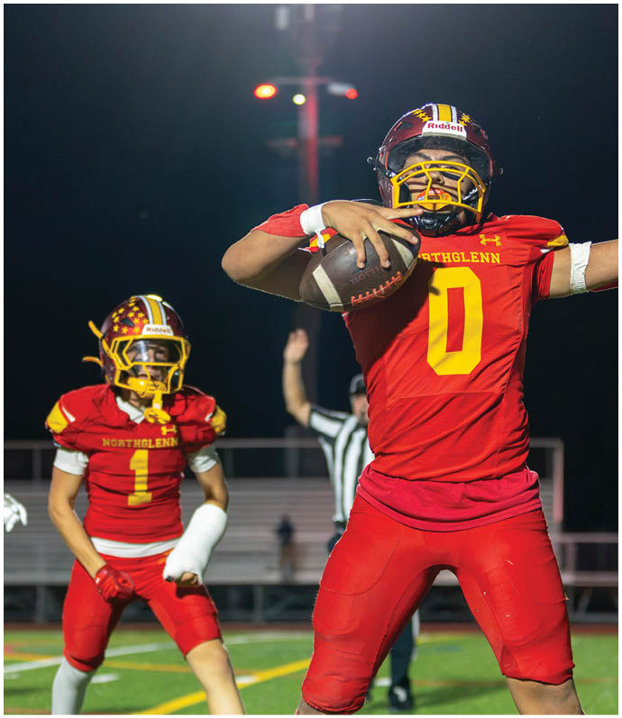 A football player wearing a red jersey with the number 0 on it. Description generated by AI