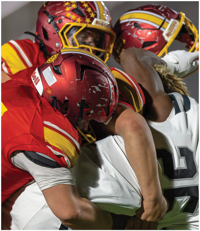 A group of football players wearing red and white uniforms. Description generated by AI