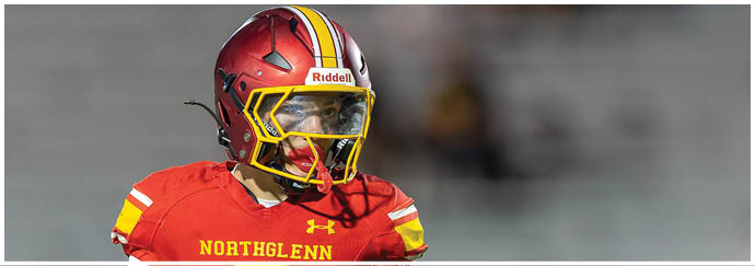 A football player wearing a red and yellow jersey with the number 5 on it. Description generated by AI