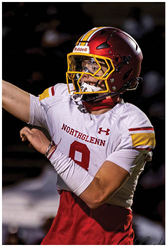 A football player wearing a red and white jersey with the number 9 on it. Description generated by AI