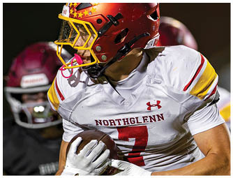 A football player wearing a red helmet and white jersey with the number 7. Description generated by AI