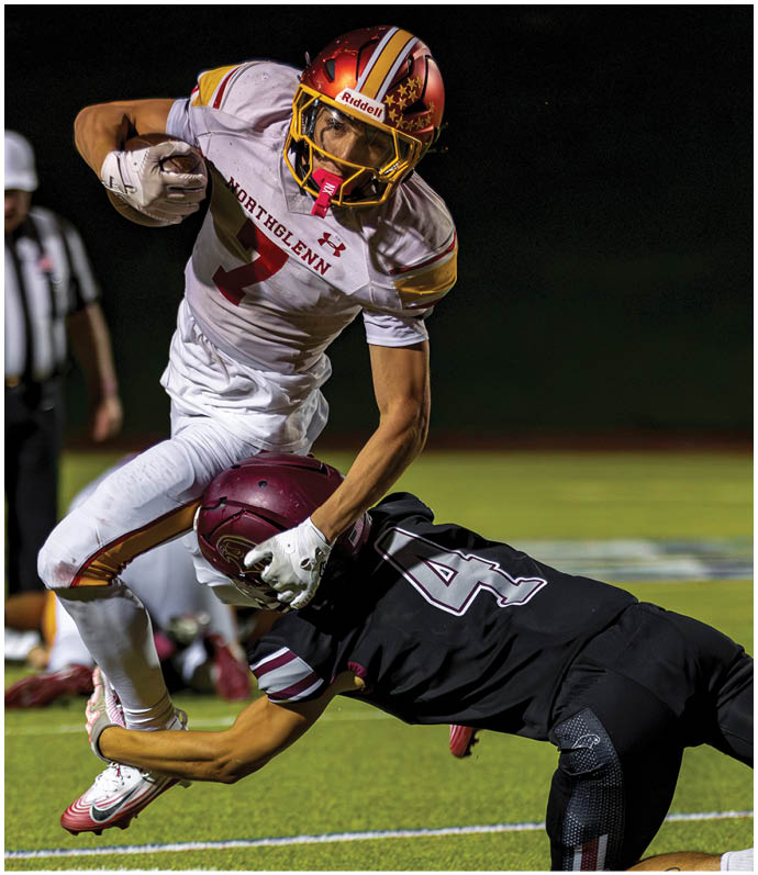 A football player in a white jersey with the number 2 on it is running with the ball. Description generated by AI