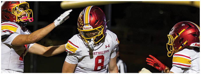 A group of football players celebrating a touchdown. Description generated by AI