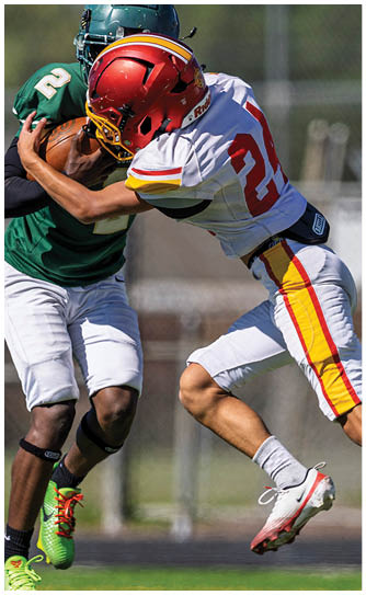A football player wearing a red and yellow jersey with the number 3 on it. Description generated by AI