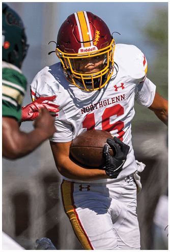 A football player wearing a red and yellow jersey with the number 8 on it. Description generated by AI