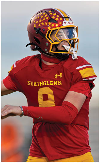 A football player wearing a red and white jersey with the number 8 on it. Description generated by AI