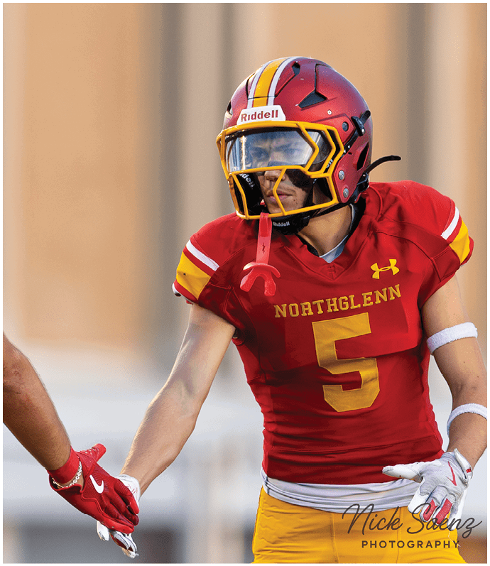 A football player in a white jersey with the number 2 on it is running with the ball. Description generated by AI