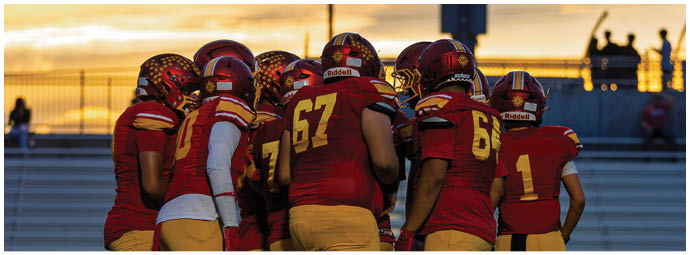 A group of football players celebrating a touchdown. Description generated by AI